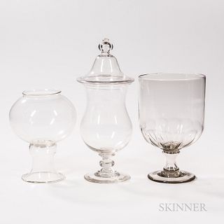 Three Large Pieces of Colorless Blown Glass, 19th century, including a bell-form footed jar with cover, a flint glass footed jar with s