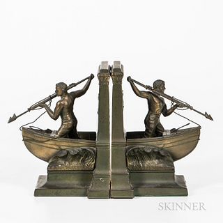 Cast Bronze Whaler Bookends, early 20th century, each with a bare-chested man standing at the bow of a whaleboat brandishing a harpoon,
