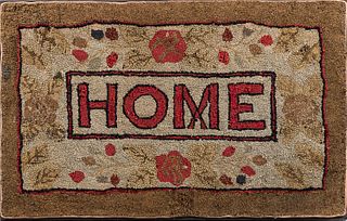 Hooked Rug "Home," early 20th century, with floral embellishments, (minor imperfections), 23 1/2 x 37 in., mounted to a stretcher.