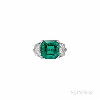 Oscar Heyman Platinum, Emerald, and Diamond Ring, set with an emerald-cut emerald measuring approx. 12.09 x 11.98 x 9.55 mm, flanked by