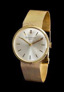 * A 14 Karat Yellow Gold Wristwatch, Baume & Mercier,