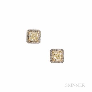 Colored Diamond Earstuds, set with cushion-cut yellow diamonds each weighing approx. 1.60 cts., framed by diamond melee, platinum and 1
