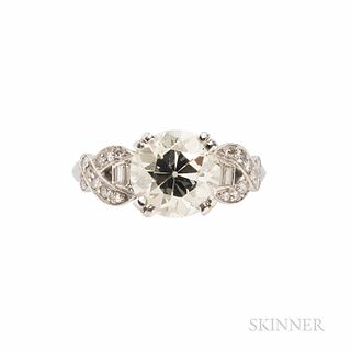 Platinum and Diamond Solitaire, set with an old European-cut diamond weighing approx. 2.60 cts., the shoulders set with baguette- and s