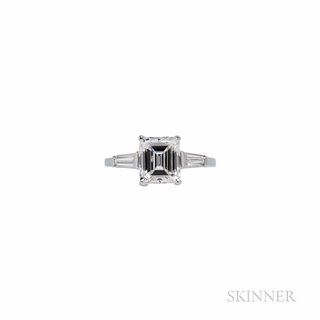 Platinum and Diamond Solitaire, prong-set with an emerald-cut diamond weighing 2.02 cts., flanked by tapered baguettes, size 6 1/4. Not