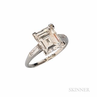 Platinum and Diamond Solitaire, set with a rectangular step-cut diamond weighing 3.24 cts., flanked by baguettes, size 6 1/2. Note: Acc