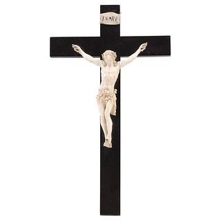 CRUCIFIED CHRIST, FRANCE, 19th century, Carved in ivory, ebonized wooden cross, 17.7 x 10.2" (45 x 26 cm)
