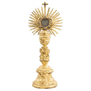 MONSTRANCE, MÉXICO, 19th century, Gilded wood carving, Decoration in the manner of vegetable figures, stem with cupids, 22.4 x 9.8 x 7.2" (57 x 25 x 1