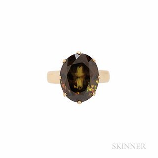 18kt Gold and Sphene Ring, the oval-cut sphene measuring approx. 15.20 x 12.00 x 8.00 mm, 6.4 dwt, size 6 1/2, British hallmarks.