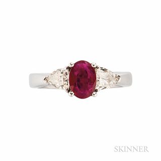 14kt White Gold, Ruby, and Diamond Ring, set with an oval-cut ruby measuring approx. 7.25 x 5.15 x 2.20 mm, flanked by fancy-cut diamon