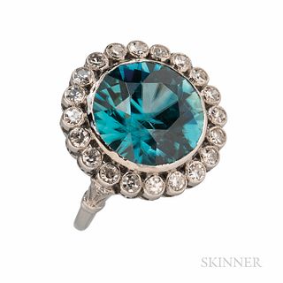 Platinum, Blue Zircon, and Diamond Ring, bezel-set with a circular-cut zircon measuring approx. 13.30 x 8.15 mm, framed by old single-c