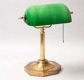 Lámpara de escritorio. Siglo XX. Estilo inglés. Elaborada en latón. Electrificada para una luz. Con pantalla de vidrio color verde.