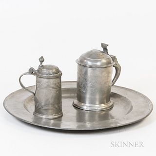 Two Pewter Tankards and a Pewter Charger, one tanker with engraved design, the charger stamped "HW," ht. to 8, dia. to 18 1/4 in.