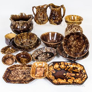Twenty-three Pieces of Rockingham-glazed and Bennington Pottery, including a Bennington center bowl, two hunt jugs, a planter with cher