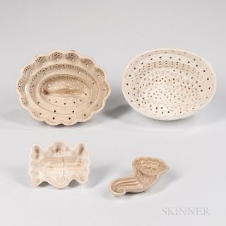 Four Staffordshire Creamware Food Molds, England, late 18th century, two tall molds with pierced sides, a small cornucopia mold, and a