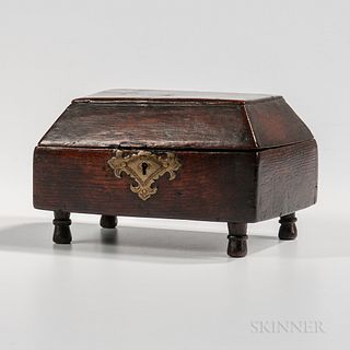 Oak Box with Chamfered Lid, England, 18th century, with large brass keyhole escutcheon and four turned legs, opening to a divided compa