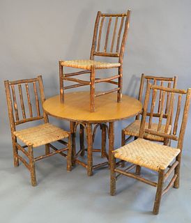 Five piece Old Hickory dinette set, including a round table with four matching side chairs with woven seats, table dia. 42", chair ht. 39".