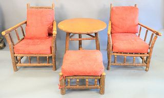 Four piece Old Hickory set, two large armchairs with matching foot stool and a circular side table, ht. 37" x dp. 32-1/2" x wd. 29".