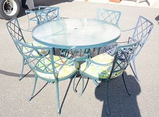 Eleven piece outdoor lot to include round glass top table, six chairs, a loveseat, and three tables.