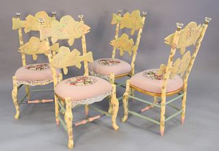Group of four Mackenzie Childs chairs, 1983, carved fish and floral needlepoint seats with mirror front rails, several pieces of mirror missing from o