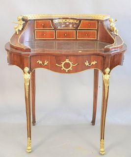 Small French oval desk, leather top, and brass figural mounts, 38 1/2" x 34 1/2" x 18".