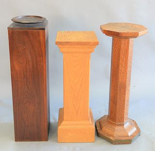 Three pedestals, square oak, octagon oak, and a square mahogany with a round revolving top, tallest ht. 37".