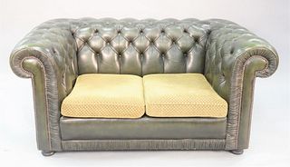 A Chesterfield style green tufted leather loveseat with upholstered cushions, 28" x 60-1/2" x 35".