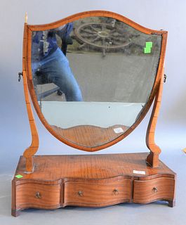 Federal flamed mahogany dressing mirror, shield shaped frame over three drawers, ht. 24", wd. 9", dp. 21".