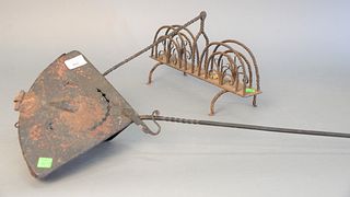 Two primitive iron pieces, toaster along with an apparatus having cover with face on it, lg. 40" (longest).
