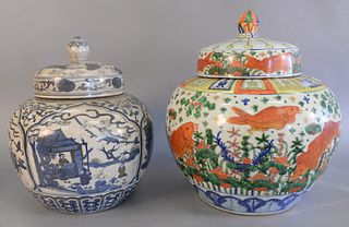 Two large Chinese porcelain covered jar Ming style with painted fish along with a blue and white jar with painted landscape scenes, approximate ht. 20