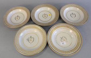Set of five Chinese Export Armorial porcelain, having gold rims and a central shield with face, minor chips, dia. 9 1/4".