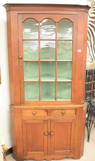 Primitive cherry two-part corner cabinet, glazed door top over two drawers and two door base, green painted interior, ht. 83", wd. 43", dp. 28 1/2".