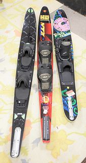 Group of three slalom skis, brands include HO Extreme, Connelly Skis and O'Brien Sixam boots included on two skis.