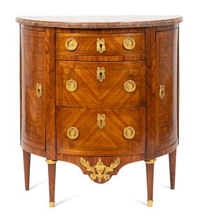 A Louis XVI Gilt-Bronze-Mounted Kingwood Demilune Commode
Height 30 x width 29 x depth 15 1/2 inches.