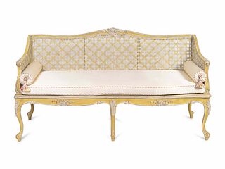 A Louis XV Style Caned and Cream-Painted Settee
Height 30 x length 59 x depth 31 inches.