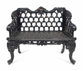 A Victorian Style Black-Painted Cast-Iron Garden Bench
Height 34 x length 42 x depth 18 inches.