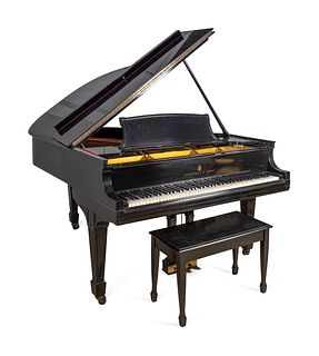 A Steinway Model L Grand Piano and Bench
Length 5'10 inches.