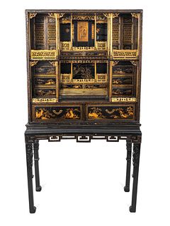 A Chinese Export Gilt Decorated Black Lacquered Cabinet-on-Stand
Height 72 x width 38 1/2 x depth 19 inches.