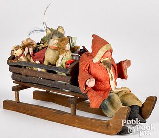 German Father Christmas in a sleigh of toys