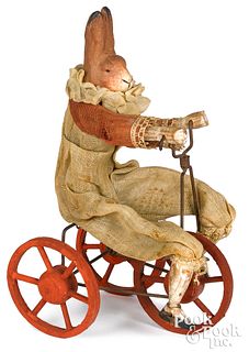 German composition rabbit riding a tricycle