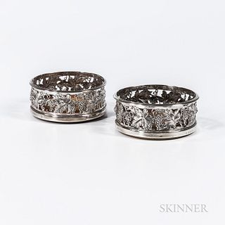 Near Pair of Sterling Silver Wine Coasters, Sheffield, one 1832-33, other 1837-38, each with indistinct maker's marks, with a reticulat