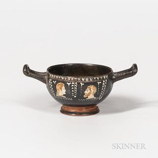Ancient Apulian Gnathian-style Stemless Kylix, c. 380-360 B.C., painted in white with red and brown highlights, the two conforming head