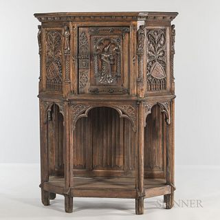 Gothic-style Carved Oak Cabinet, late 19th/early 20th century, with an upper cabinet door with a central robed figure of a woman raised