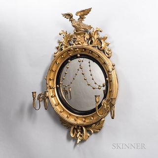 Neoclassical Giltwood Convex Mirror, with an eagle crest supporting pendant swags, with a pair of lower two-light sconces, ht. 47 1/2,