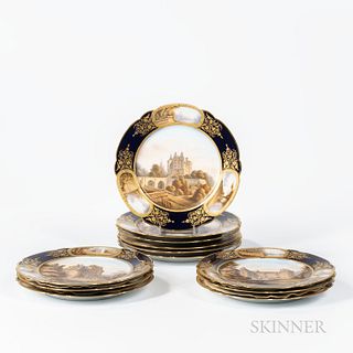 Twelve Sevres Porcelain Landscape Plates, France, late 19th century, each gilded and with polychrome enamel depicting a chateau centeri