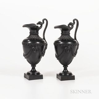 Pair of Neale Black Basalt Ewers, England, late 18th century, each with heart-shaped spout and scrolled handle with bird head and termi