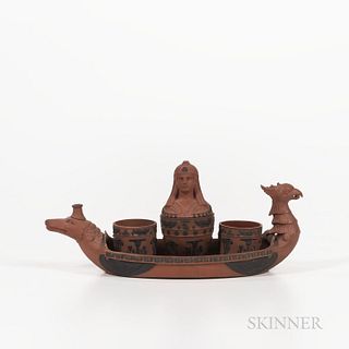 Wedgwood Rosso Antico Egyptian Inkstand, England, early 19th century, modeled as a ship with a griffin's head at the prow and crocodile