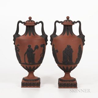 Pair of Wedgwood Rosso Antico Vases and Covers, England, early 19th century, applied black basalt relief with Bacchus masks and horn ha