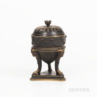 Wedgwood Gilded and Bronzed Black Basalt Urn and Cover, England, c. 1885, floral finial to a domed cover, the urn with floral festoons