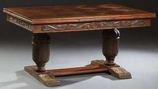 Jacobean Style Carved Oak Drawleaf Table, 20th c., the parquetry inlaid top over a wide carved skirt, on urn form supports to a trestle base, H.- 28 3