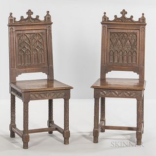 Six Gothic-style Oak Side Chairs, late 19th/early 20th century, each with a paneled back carved with gothic tracery, ht. 40, wd. 14 5/8